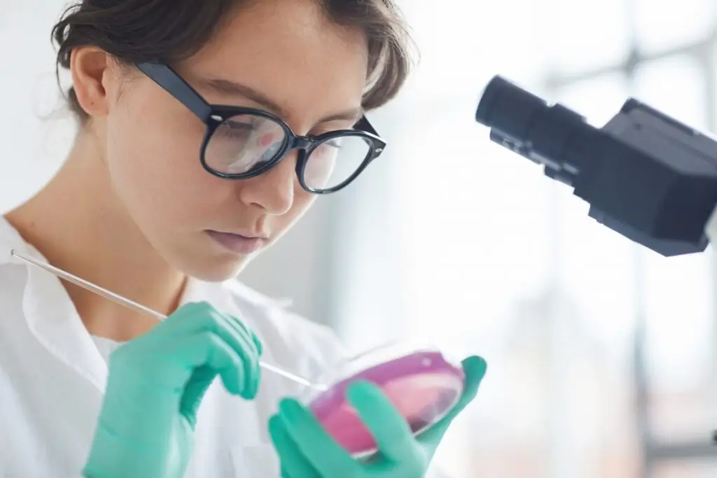 Young Woman Holding Petri Dish