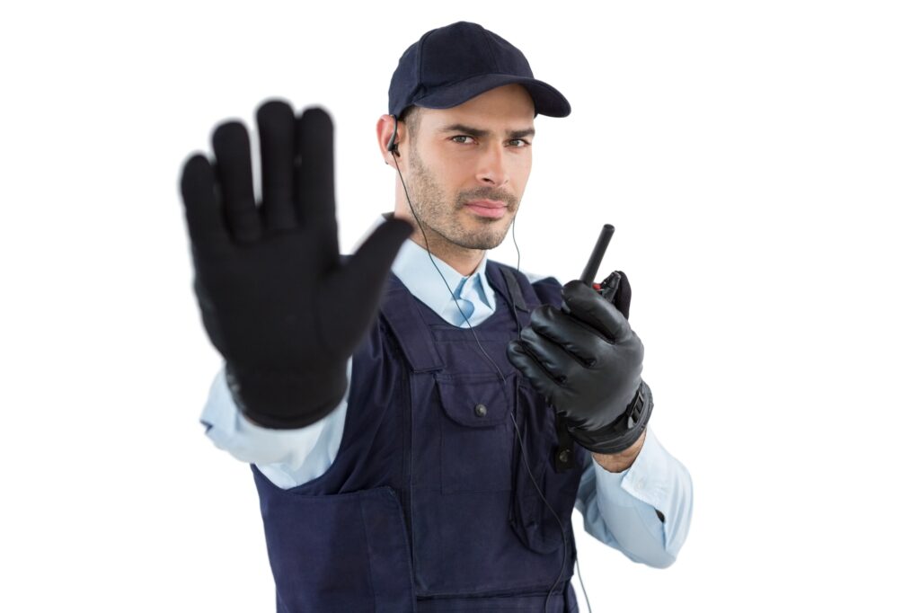 Confident security officer making stop gesture