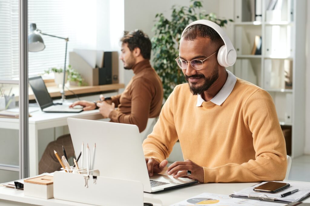 Manager in headphones working in office