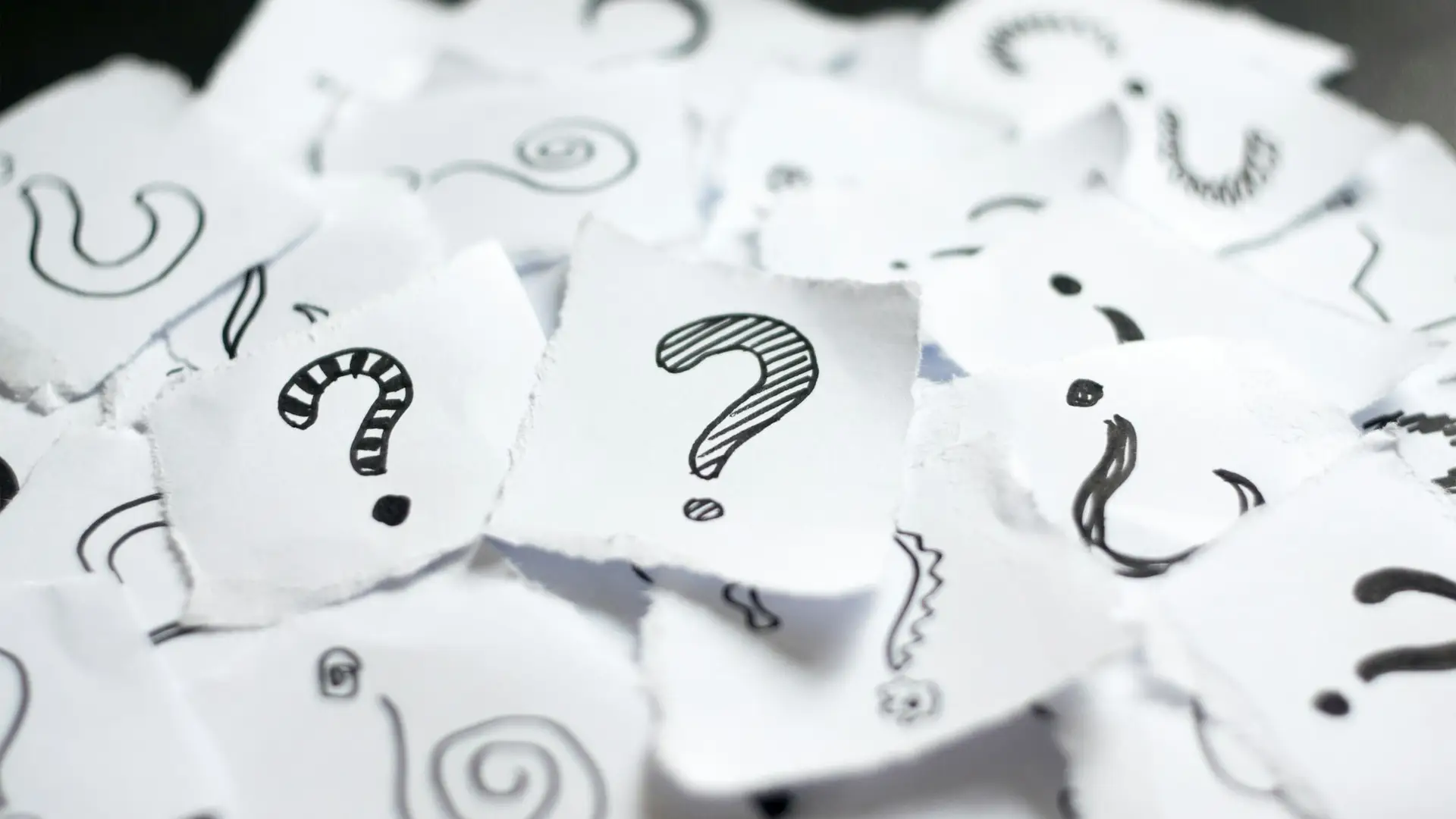 Twaalf tips voor inspiratie om te bloggen 8 Many question marks on white papers. Doodle drawn question marks on scraps of paper. Choice