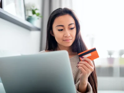 asian-girl-making-online-payment-using-laptop-for-shopping-at-home