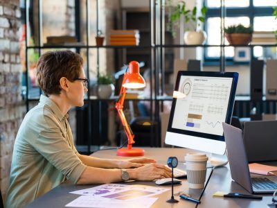 Businesswoman working with statistics on computer