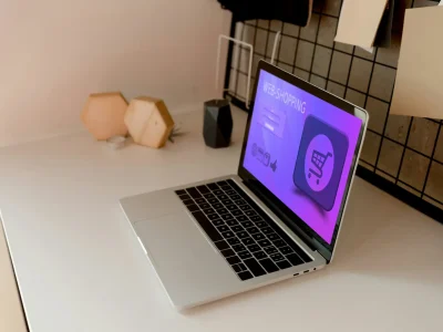 close up view of digital laptop with web shopping lettering on tabletop at home