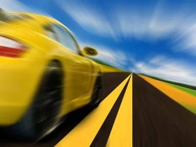 High-speed motion-blurred auto on rural highway