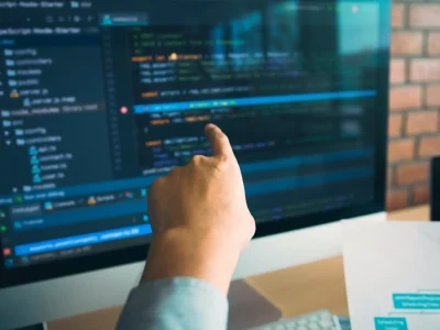 Man hands pointing coding html and programming develop on screen computer.