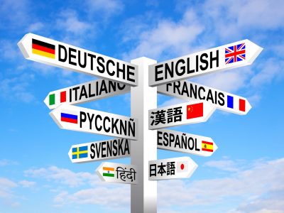 Man working on a laptop with the word translate on the computer screen