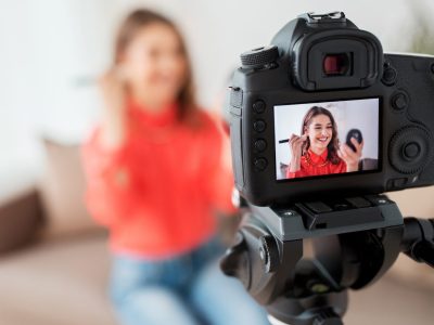 woman-with-bronzer-and-camera-recording-video